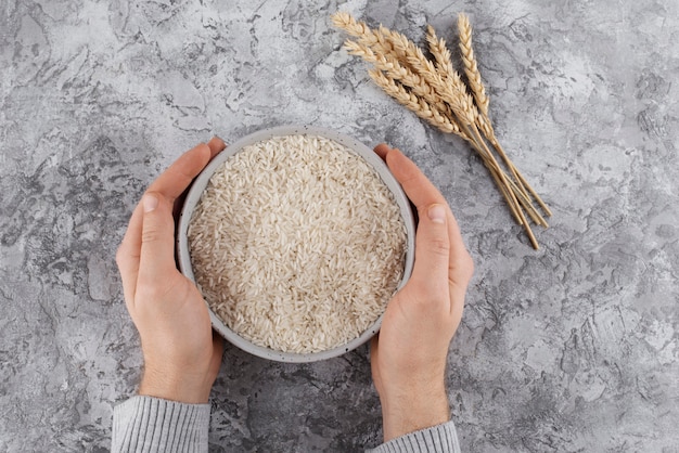 Top view hands holding bowl with rice