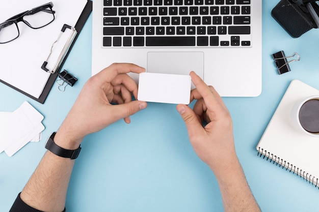 Top view of hands holding business card