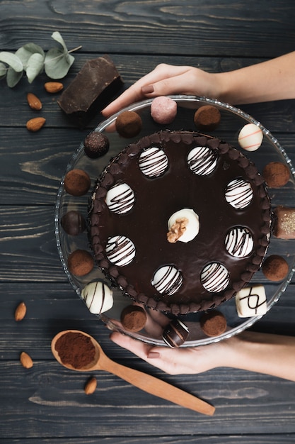 Top view hands holding chocolate cake