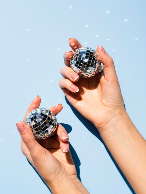 Top view hands holding disco globes