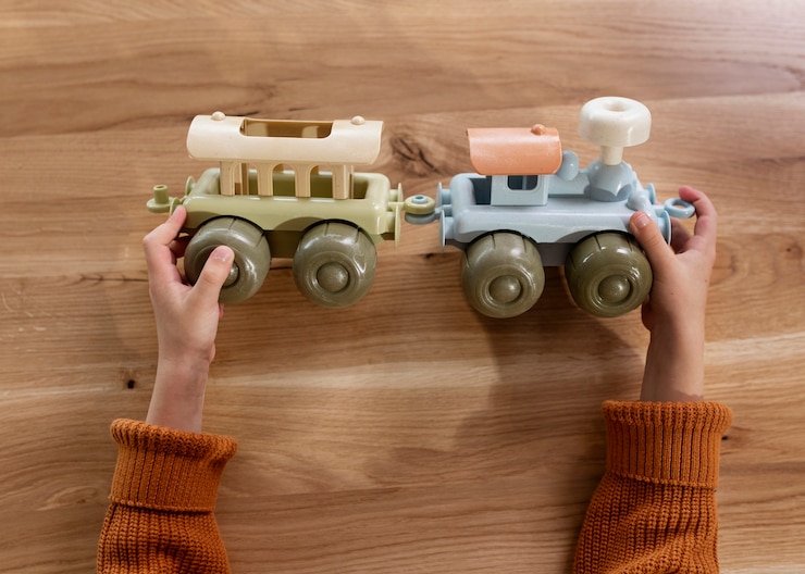 Free Photo top view hands holding eco toy