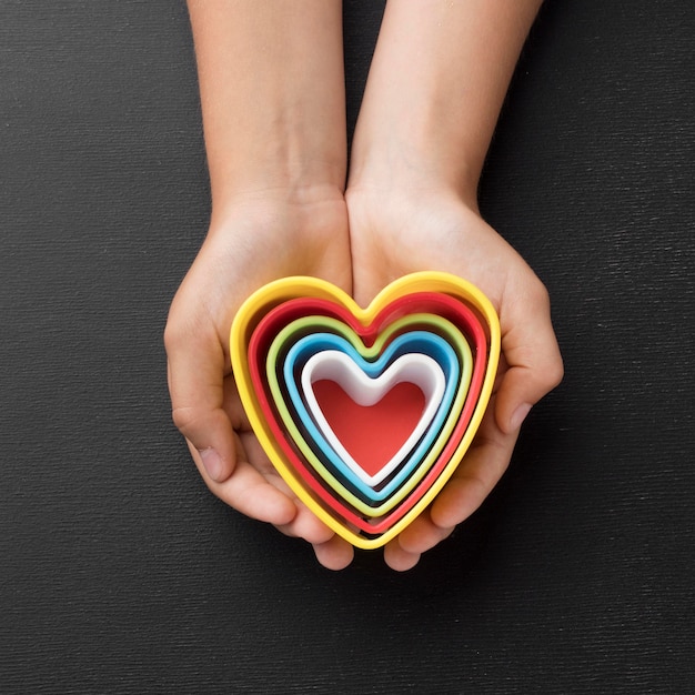 Top view hands holding elements in shape of hearts