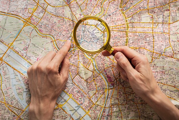 Top view hands holding magnifying glass