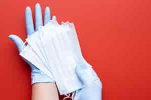 Free photo top view of hands holding medical masks