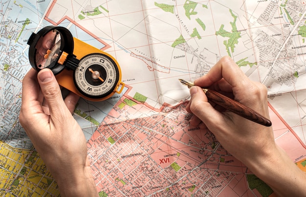 Top view hands holding pencil and compass