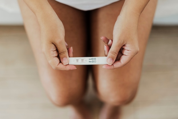 Top view hands  holding positive pregnancy test
