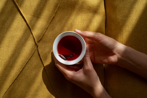 Free photo top view hands holding tea cup