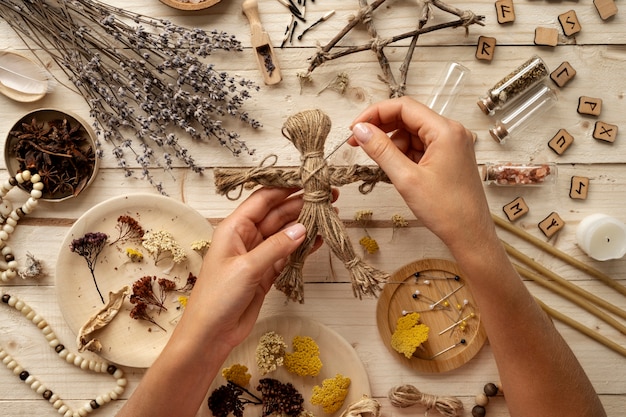 Top view hands holding voodoo doll and needle