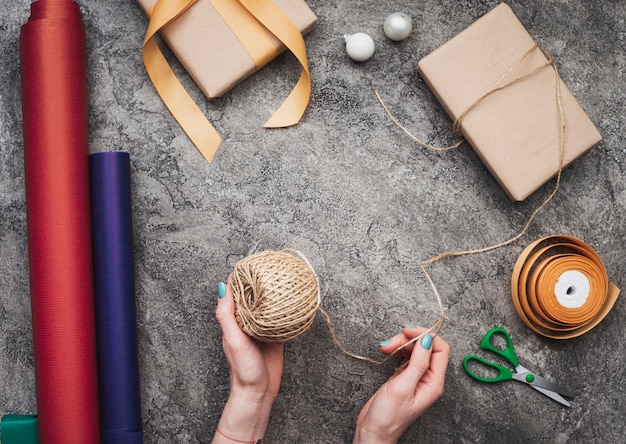 Top view of hands packing christmas gifts