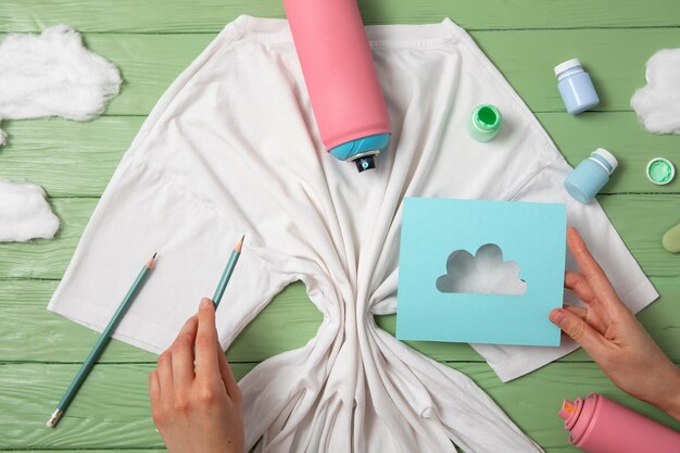 Top view hands painting  t-shirt still life