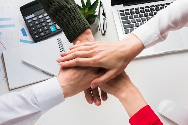 Top view of hands together over work desk