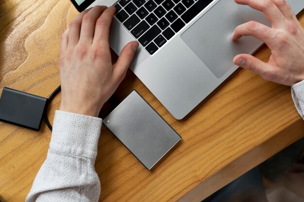 Top view hands using laptop at desk