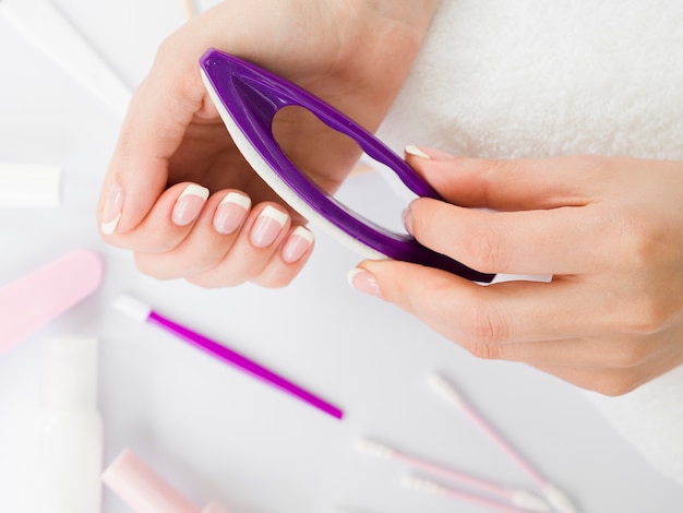 Top view hands using manicure tools