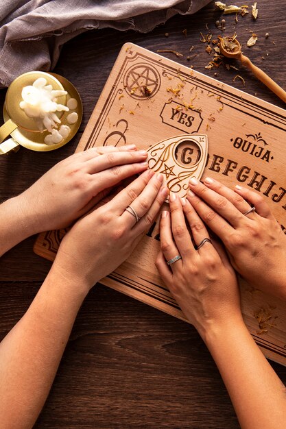 Top view hands using ouija board