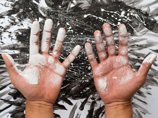 Top view of hands with palms covered in paint