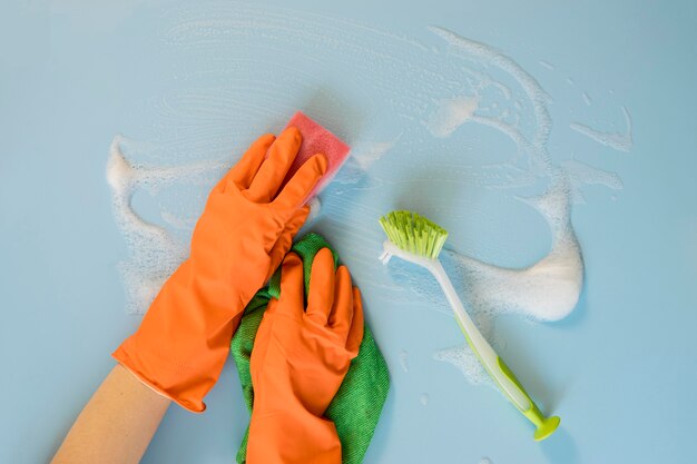 Top view hands with rubber gloves cleaning