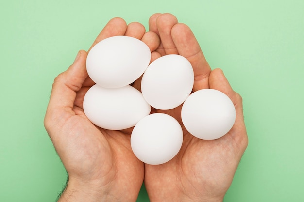 Top view hands with white eggs