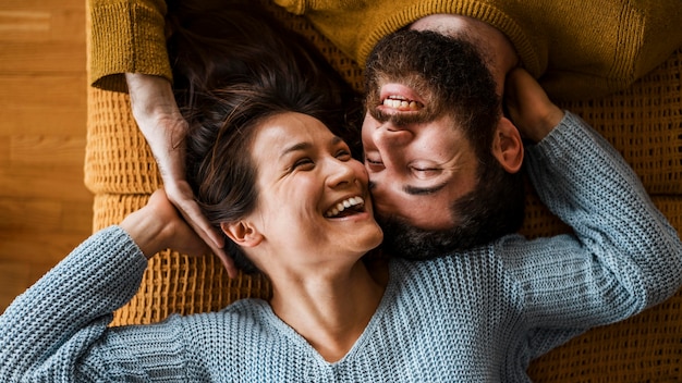 Free photo top view happy couple laying together