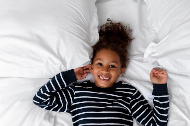 Top view happy girl in bed