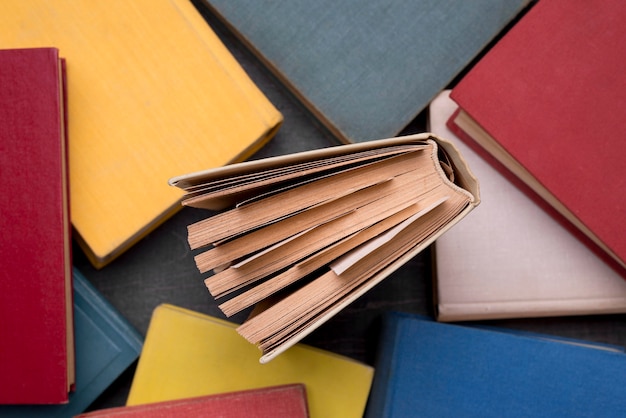 Top view of hardback books with one in the middle