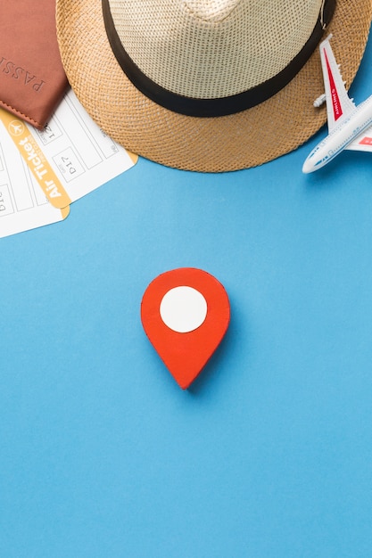 Free photo top view of hat and travel essentials with pinpoint