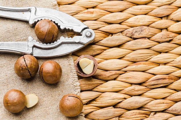 Free photo top view hazelnuts with nut cracker