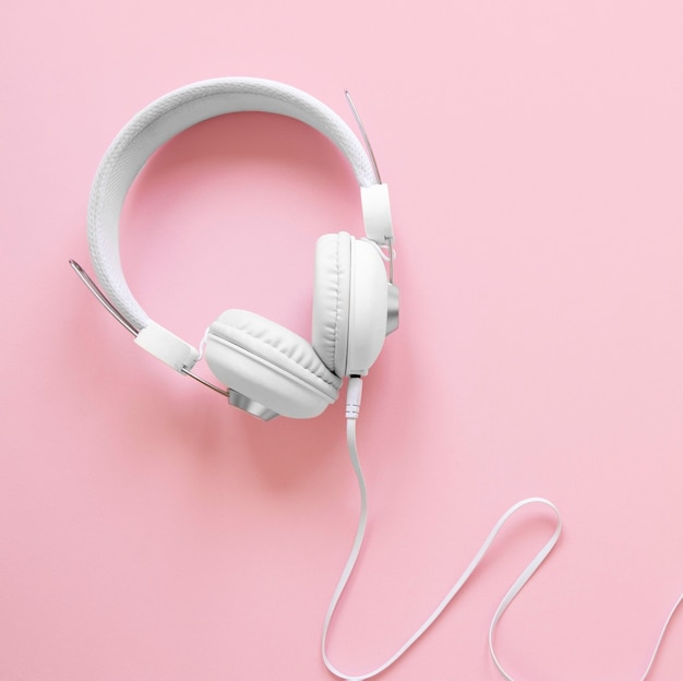 Top view headphones on pink background