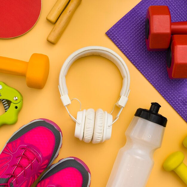 Top view of headphones with sport essentials