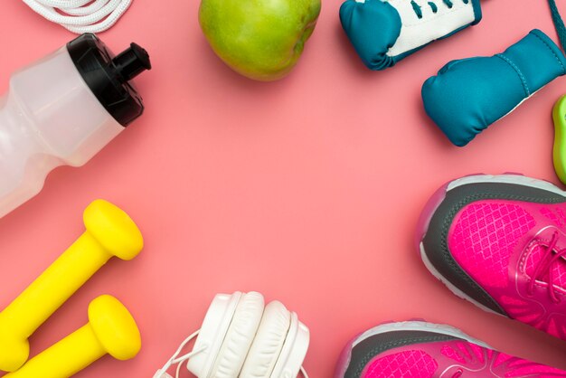 Top view of headphones with weights and sport essentials