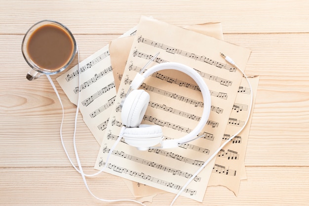 Free photo top view headset with music sheets