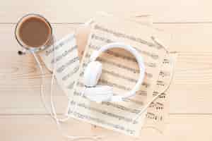 Free photo top view headset with music sheets