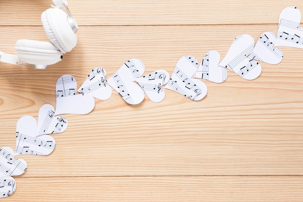 Free photo top view headset with paper hearts