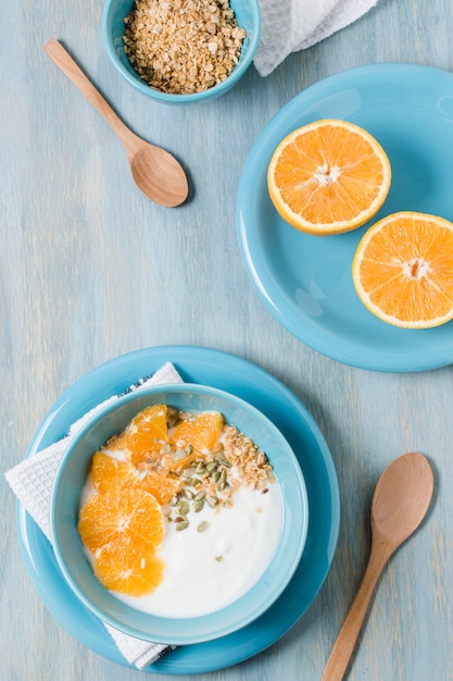 Top view healthy breakfast bowl with orange