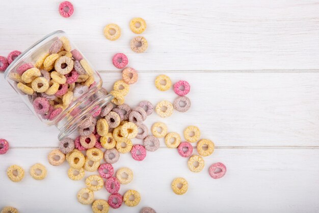 Top view of healthy and colorful cereals on a glass jar with cereals isolated on white surface