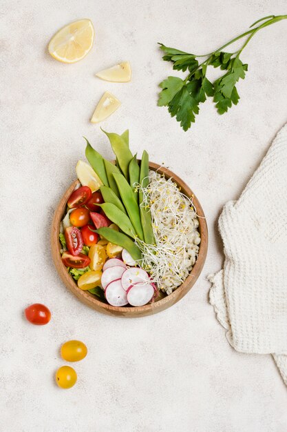 Top view of healthy food in bowl with tomatoes