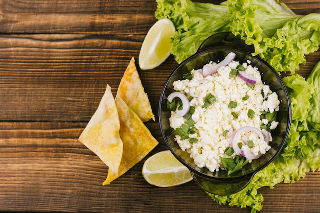 Top view healthy mexican food with lettuce and lemon