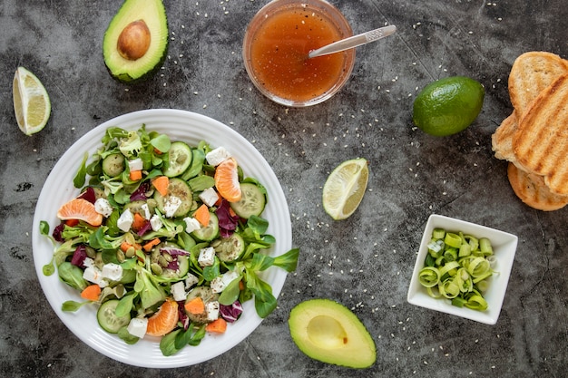 Top view healthy salad with avocado and toast