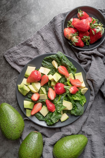 Top view healthy salad with strawberries and avocado