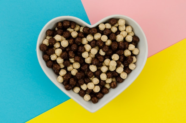 Top view heart shape bowl full with cereals