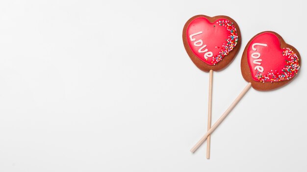 Top view of heart-shaped cookies on sticks