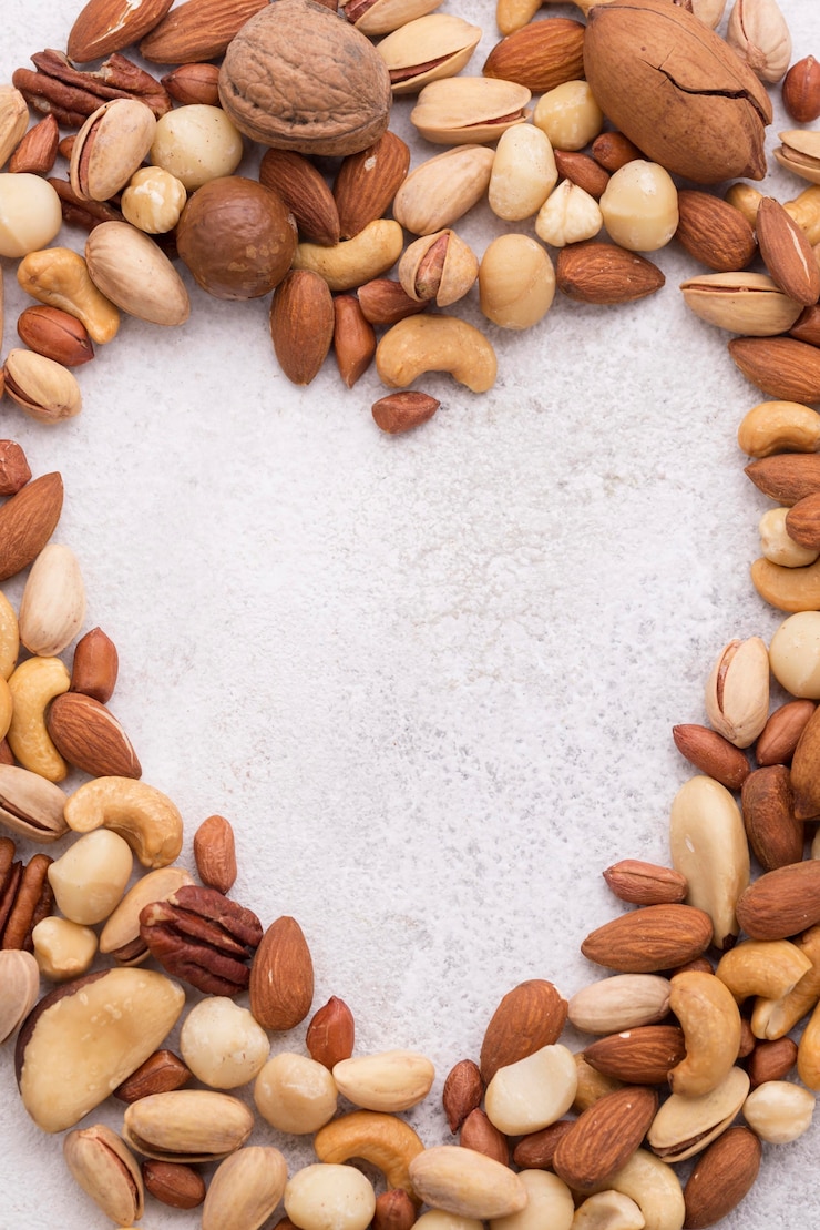 Free Photo top view heart shaped copy spaces and nuts