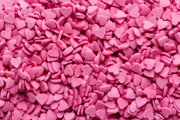 Free photo top view of heart-shaped pink sweets