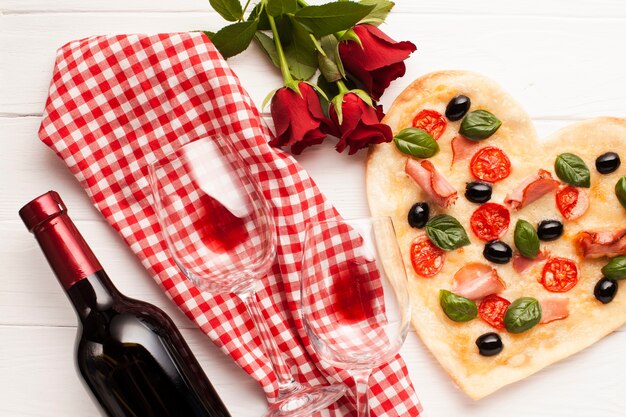 Top view heart shaped pizza dinner arrangement