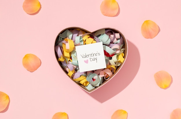 Top view of heart-shaped tin box with confetti for valentines day