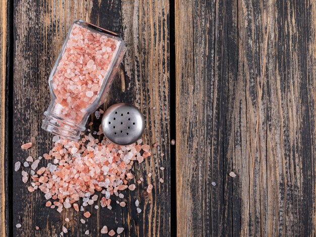 Top view of himalayan salt coming out of open salt shaker