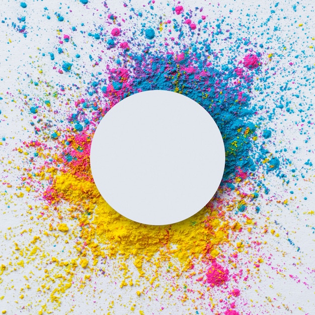 Free photo top view of holi color on a white background with blank circle