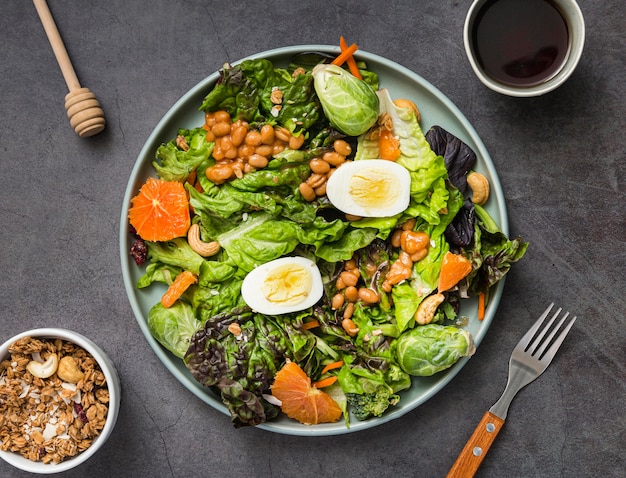 Top view homemade breakfast with lettuce and eggs