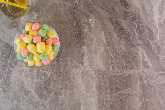 Top view of homemade colorful candies on grey.