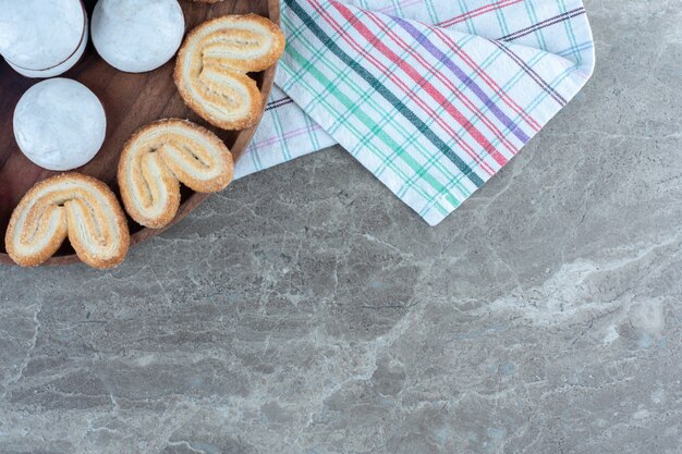 Top view of homemade cookies on wooden board.