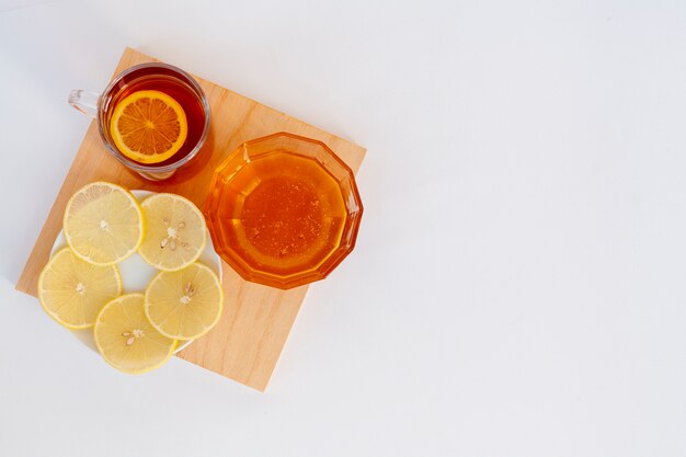 Top view homemade honey with lemon slices